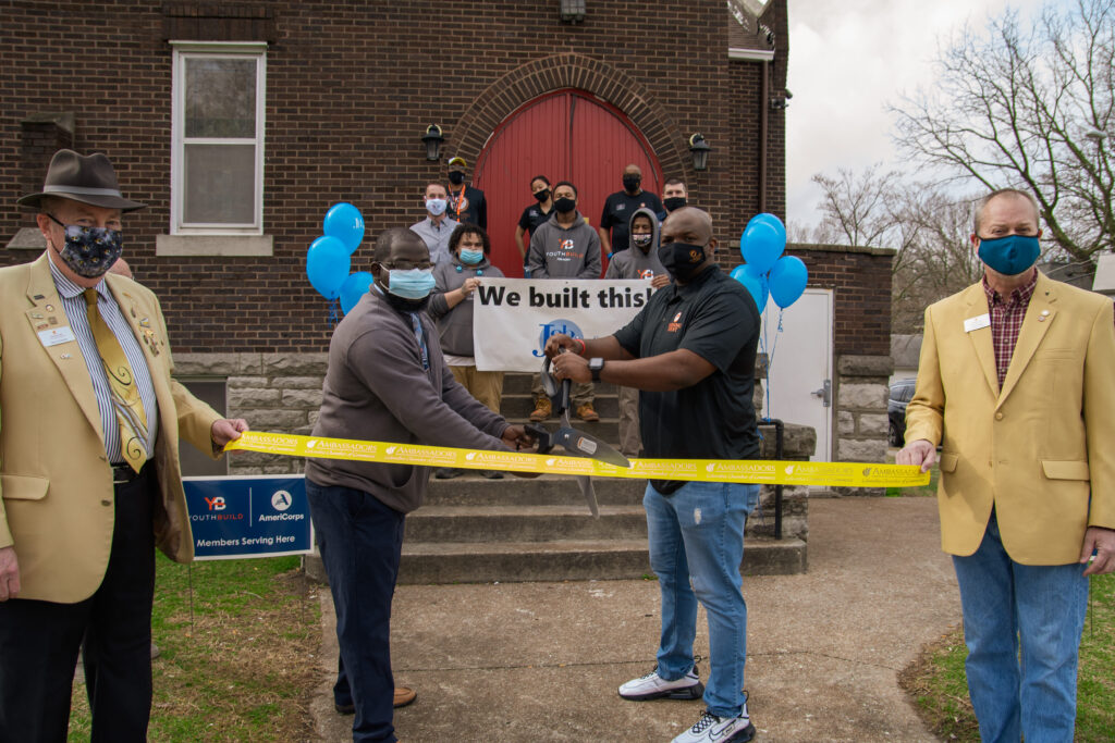 Staff and Community gather for a ribbon cutting in front of the church