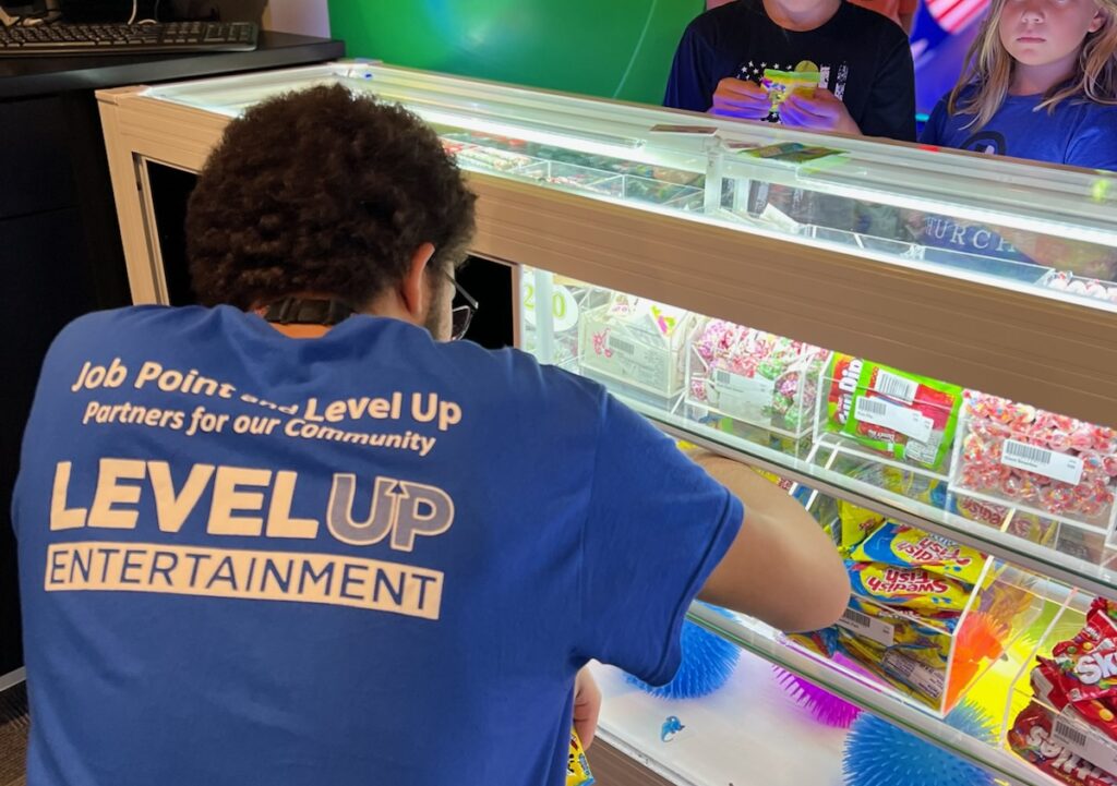 Student helps guests with picking out their prizes at Level Up in Columbia, MO