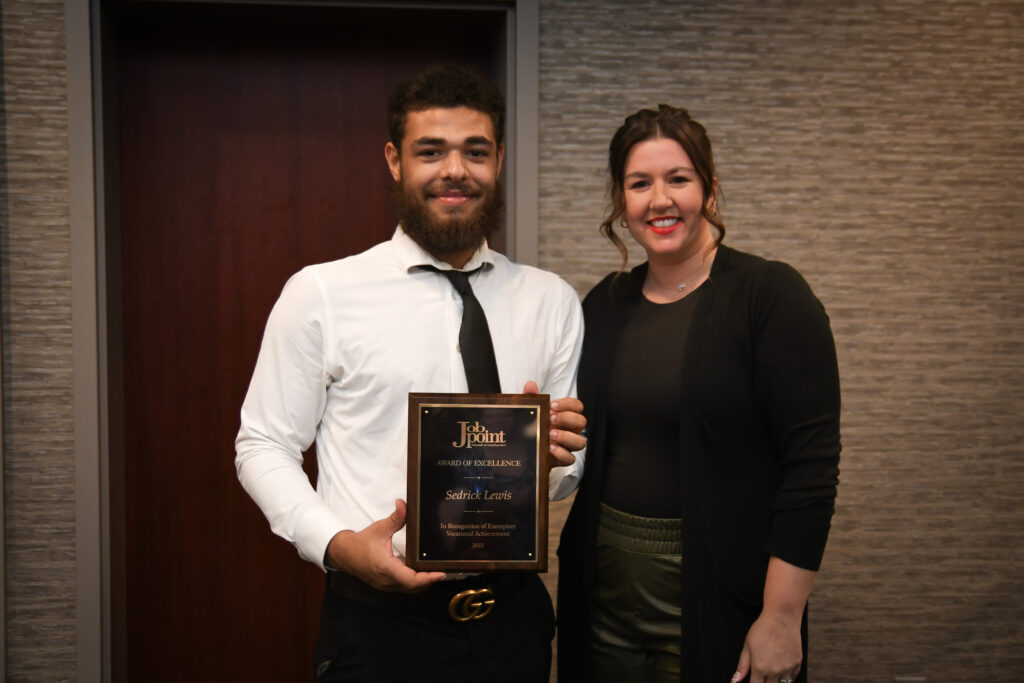 Sedrick Lewis stands with Lauren Karr, Board President at the Awards banquet.