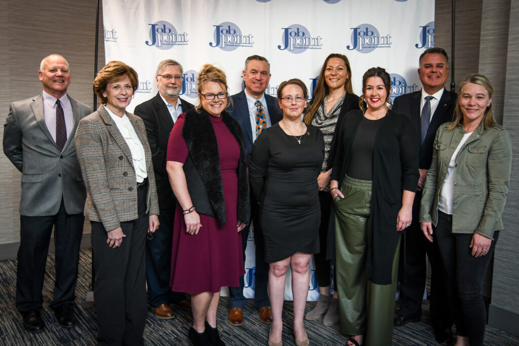 Part of Job Point's Board of Directors stands in front of a backdrop