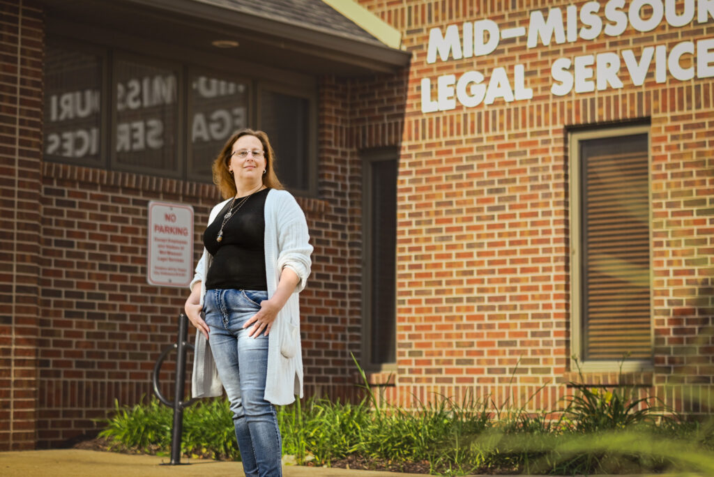 Mary Hall stands in front of Mid-Missouri Legal Services.