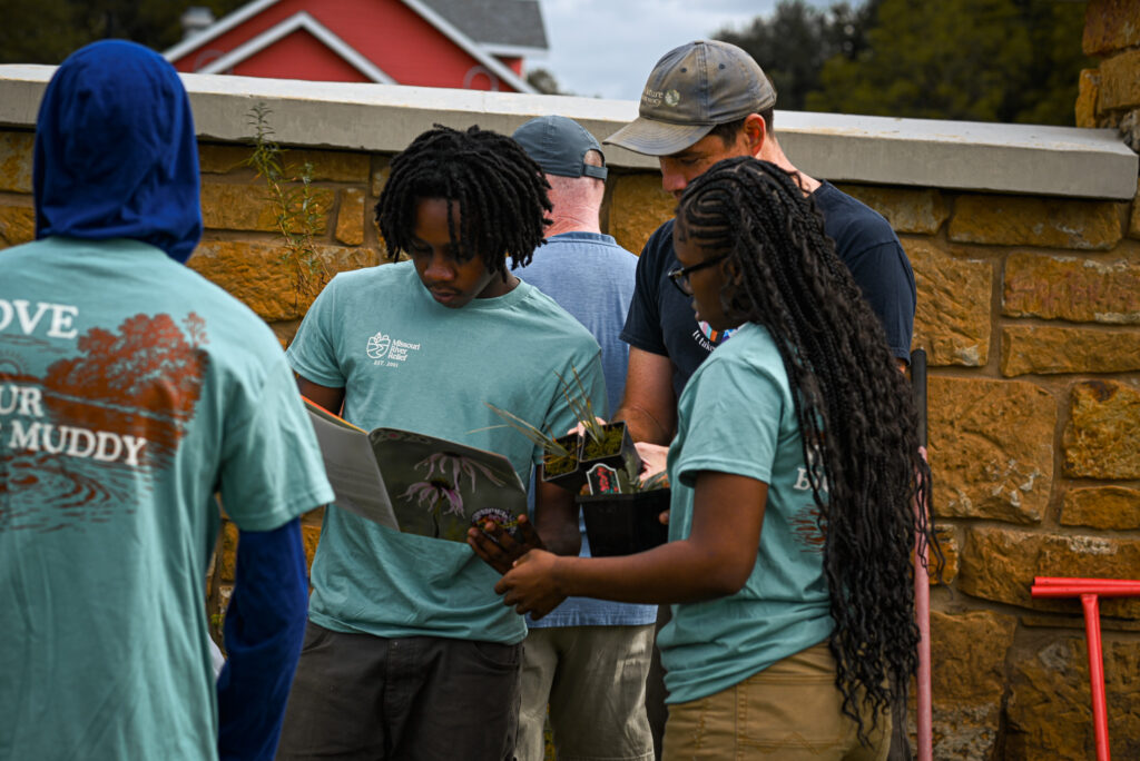 Students figure out how to plant their native plants.