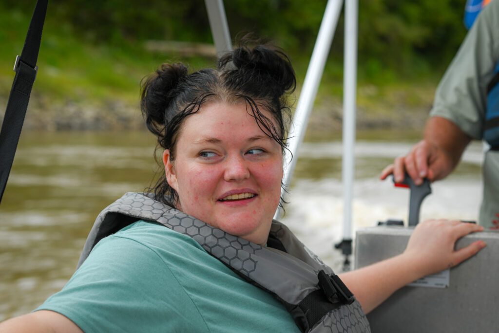 A young girl smiles through her fear.
