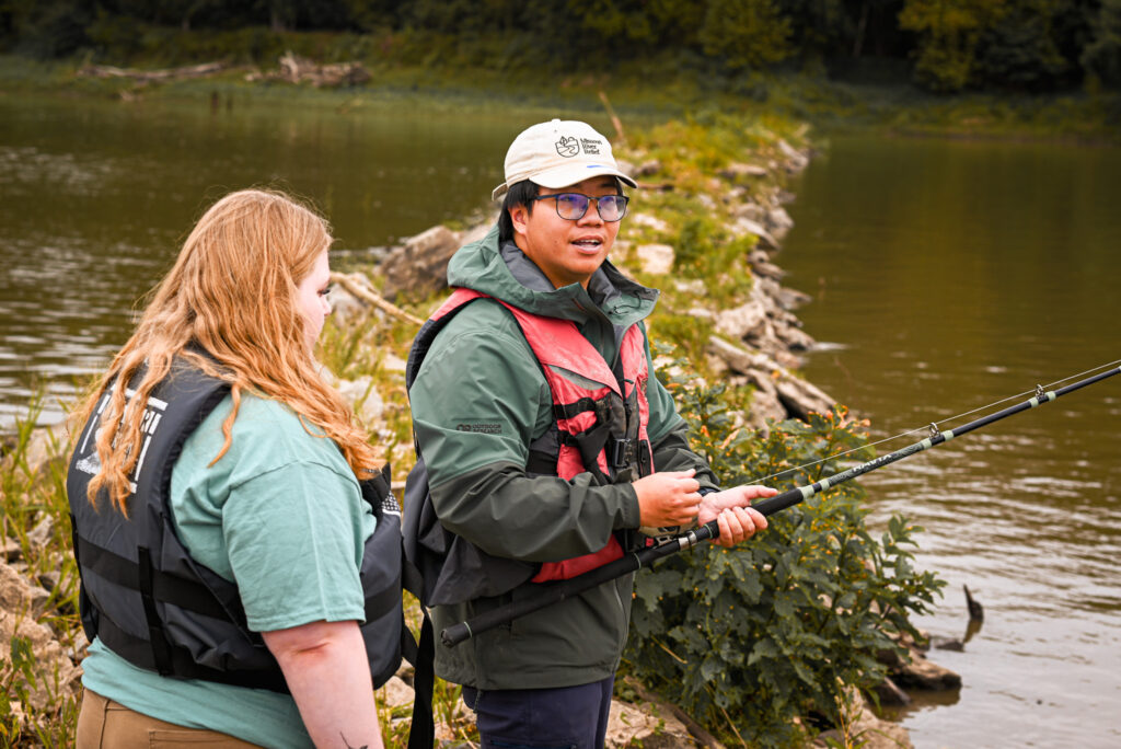 A catfishing instructor teaches a young woman about how to cast her line.